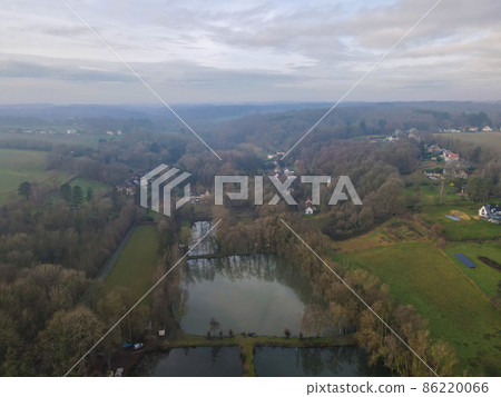Aerial view of houses surrounded by forest in the country side area of Walloon, Belgium 86220066