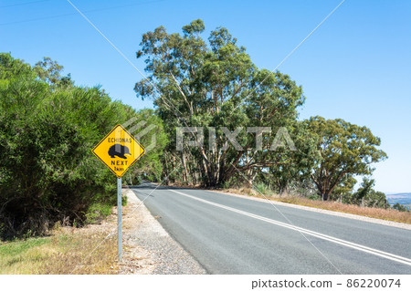Echidnas Crossing Next 1km road sign in Australia. 86220074