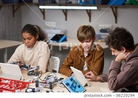 Teenagers projecting robots on computers 86220294