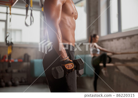 Young man standing in the fitness club Young man standing in the fitness club 86220315