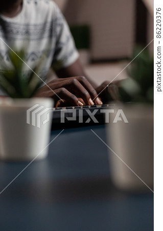 Closeup of university student hands typing project information 86220376