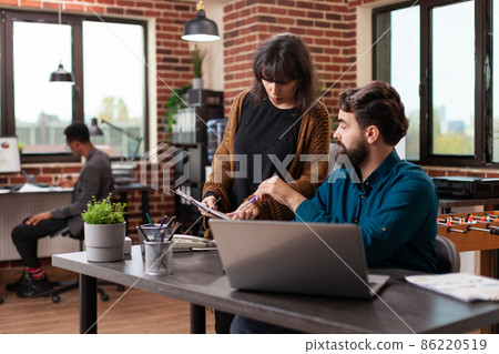 Businesswoman showing marketing charts to man leader 86220519