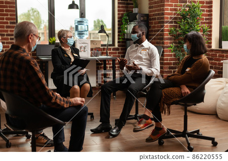 Multi ethnic people discussing about addiction at support group therapy Multi ethnic people discussing about addiction at support group therapy 86220555