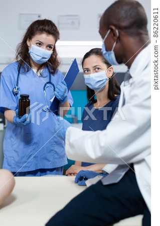 African american pediatrician doctor with protection face mask against coronavirus African american pediatrician doctor with protection face mask against coronavirus 86220611