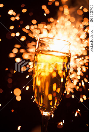 champagne glass against christmas sparkler background 86220703