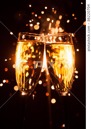 champagne glass against christmas sparkler background 86220704