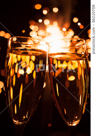 champagne glass against christmas sparkler background 86220706