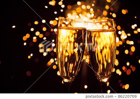 champagne glass against christmas sparkler background 86220709