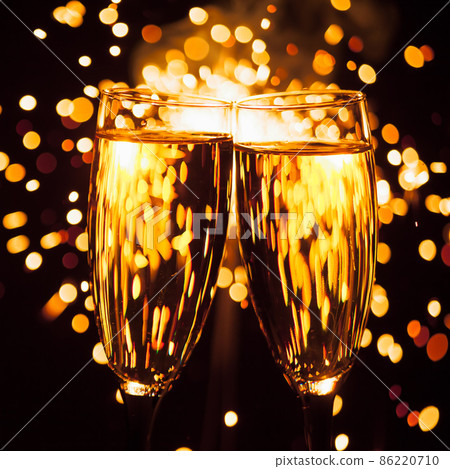 champagne glass against christmas sparkler background 86220710