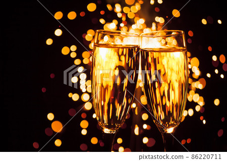 champagne glass against christmas sparkler background 86220711