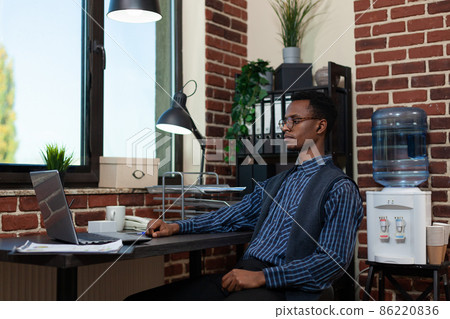 Entrepreneur sitting at desk in video call conference briefing about business results using laptop 86220836