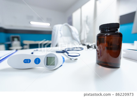 Selective focus on medical tools standing on table in empty doctos office Selective focus on medical tools standing on table in empty doctos office 86220973