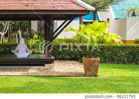 Woman in gazebo practicing yoga in Thailand in Asia Woman in gazebo practicing yoga in Thailand in Asia 86221765