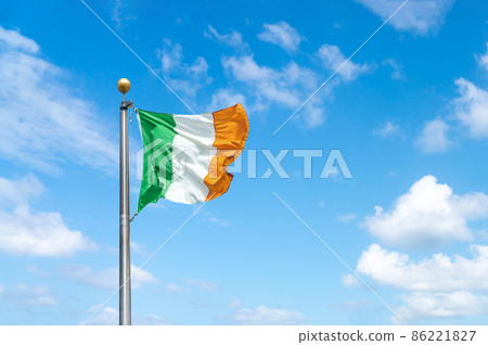 Irish tricolour flying in full sunshine against blue sky Irish tricolour flying in full sunshine against blue sky 86221827