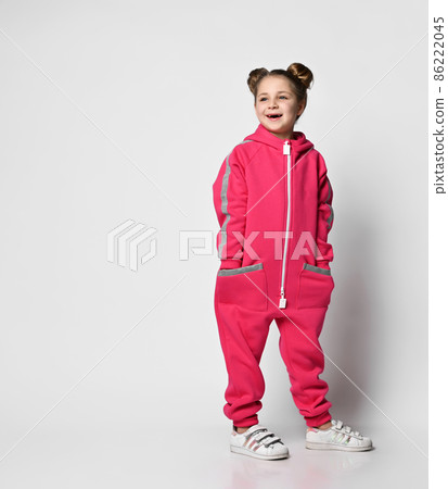 smiling girl in a pink modern jumpsuit with smiling girl in a pink modern jumpsuit with 86222045