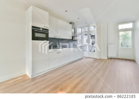 Bright kitchen with white cabinets and silver appliances Bright kitchen with white cabinets and silver appliances 86222185
