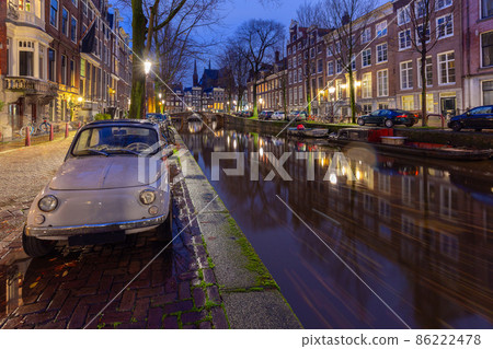 Beautiful old houses on the city waterfront of Amsterdam at sunset. 86222478