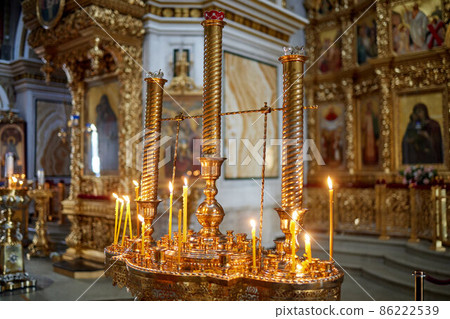 burning church candles near the altar. Close-up. 86222539