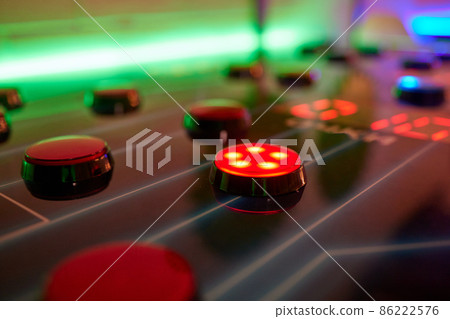 Joystick and button controls of a vintage arcade video game in a dark room. Joystick and button controls of a vintage arcade video game in a dark room. 86222576