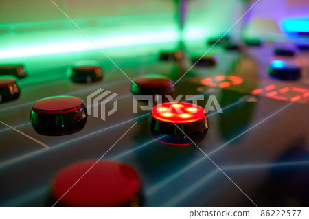 Joystick and button controls of a vintage arcade video game in a dark room. Joystick and button controls of a vintage arcade video game in a dark room. 86222577