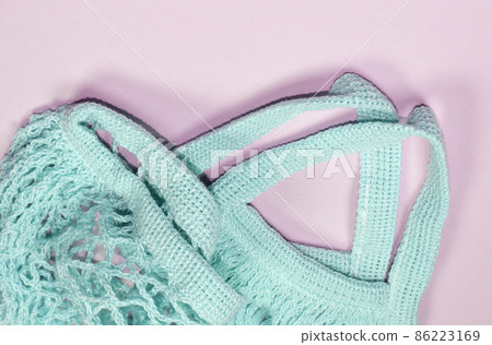 Empty mesh bag on pink background, top view. Space for text, eco-friendly shopping bag Empty mesh bag on pink background, top view. Space for text, eco-friendly shopping bag 86223169