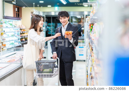 A young couple shopping for groceries at a supermarket A young couple shopping for groceries at a supermarket 86226086