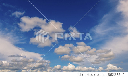 Blue sky fluffy white clouds on summer season bright clear skyline with beautiful cloudscape. Panorama blue sky clouds pattern on daylight with copy space. Cumulus cloudscape air climate sunny day Blue sky fluffy white clouds on summer season bright clear skyline with beautiful cloudscape. Panorama blue sky clouds pattern on daylight with copy space. Cumulus cloudscape air climate sunny day 86227241