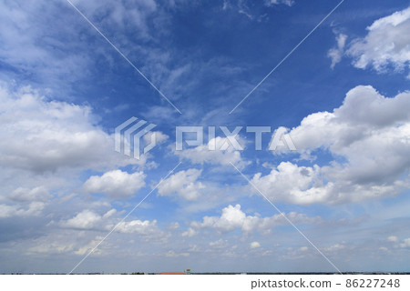Blue sky fluffy white clouds on summer season bright clear skyline with beautiful cloudscape. Panorama blue sky clouds pattern on daylight with copy space. Cumulus cloudscape air climate sunny day Blue sky fluffy white clouds on summer season bright clear skyline with beautiful cloudscape. Panorama blue sky clouds pattern on daylight with copy space. Cumulus cloudscape air climate sunny day 86227248