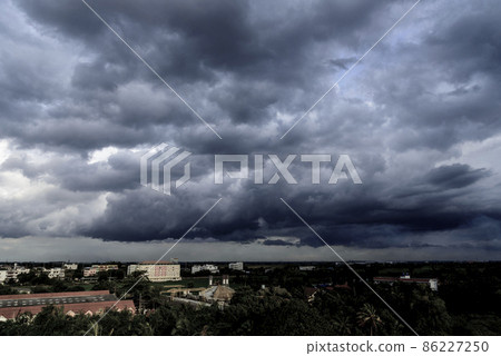 Dramatic dark storm rain clouds black sky background. Dark thunderstorm clouds rainny atmosphere. Meteorology danger windstorm disasters climate. Dark cloudscape storm disaster gloomy gray cloud sky Dramatic dark storm rain clouds black sky background. Dark thunderstorm clouds rainny atmosphere. Meteorology danger windstorm disasters climate. Dark cloudscape storm disaster gloomy gray cloud sky 86227250