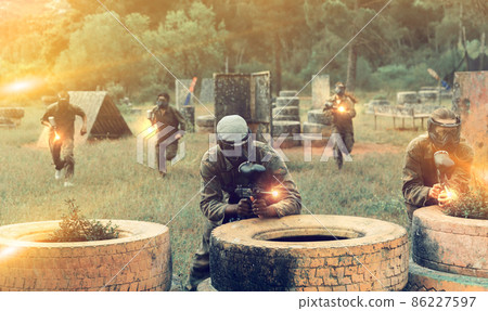 Paintball players of opposite teams in shootout Paintball players of opposite teams in shootout 86227597