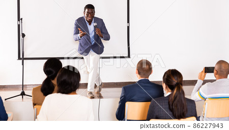 Young emotional male coach giving motivational speech Young emotional male coach giving motivational speech 86227943
