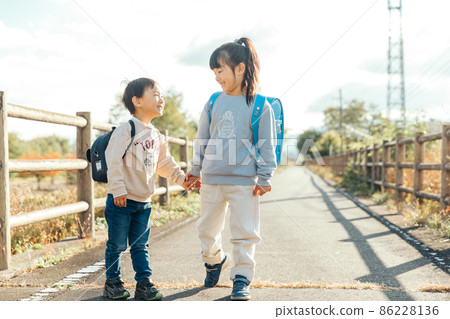 Innocent, a child who holds hands and smiles 86228136
