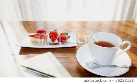 Strawberry sweets, tea and schedule notes on the table by the window Strawberry sweets, tea and schedule notes on the table by the window 86228181