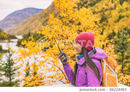 Autumn hiker camping woman talking on ham radio 86228965