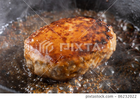 Steaming juicy hamburger steak 86232022
