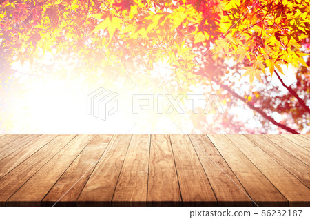 Wooden table top with orange fall leaves, autumn natural background Wooden table top with orange fall leaves, autumn natural background 86232187