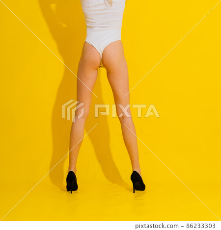 Beautiful woman legs in high heels, white bodysuit panties - studio Beautiful woman legs in high heels, white bodysuit panties - studio 86233303