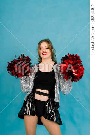 Beautiful young adult cheerleader female, studio red and blue background Beautiful young adult cheerleader female, studio red and blue background 86233304