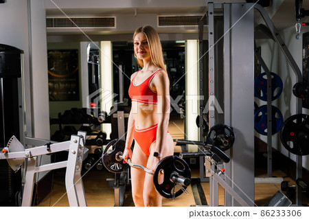 Sport female with dumbbells and boxer gloves in the gym 86233306