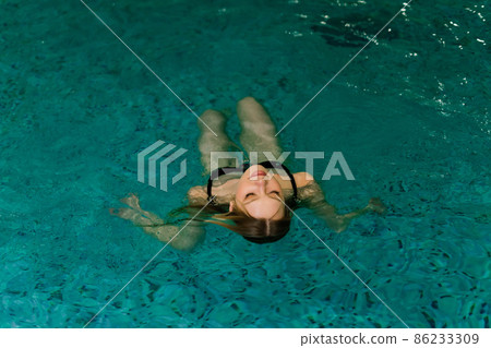 Portrait of beautiful woman in swimwear relaxing in swimming pool spa. Portrait of beautiful woman in swimwear relaxing in swimming pool spa. 86233309