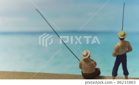 Two male dolls fishing in the blue sea 86233863
