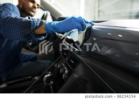 A man cleaning car interior, car detailing in Carwash service 86234154