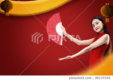 Asian Chinese woman in a cheongsam dress holding fan with open palm showing something Asian Chinese woman in a cheongsam dress holding fan with open palm showing something 86234348
