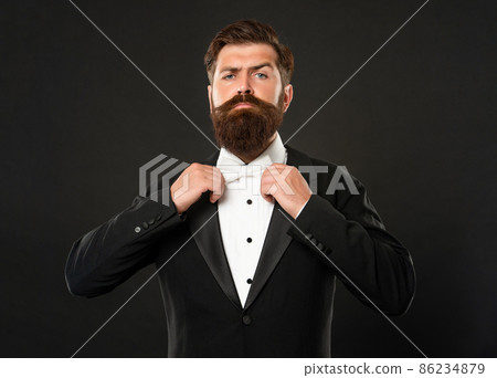 bearded groom in tuxedo on black background, bow tie bearded groom in tuxedo on black background, bow tie 86234879