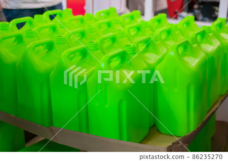 Many empty green plastic jerrycans 86235270