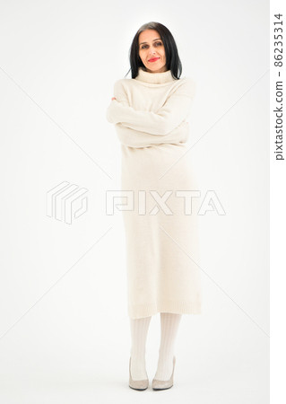 Middle aged woman starting getting grey-haired is posing in studio in sweater on white background, face skin care beauty, middle age skincare cosmetics, cosmetology concept Middle aged woman starting getting grey-haired is posing in studio in sweater on white background, face skin care beauty, middle age skincare cosmetics, cosmetology concept 86235314