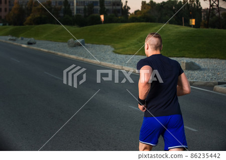 Close-up portrait of athletic man running Close-up portrait of athletic man running 86235442