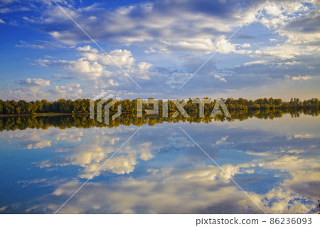 The autumn wood which is reflected in water The autumn wood which is reflected in water 86236093