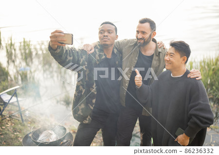 Men take selfie on smartphone and rest in nature Men take selfie on smartphone and rest in nature 86236332