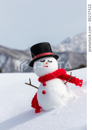 Snowman in snowy mountains and top hat 86237428